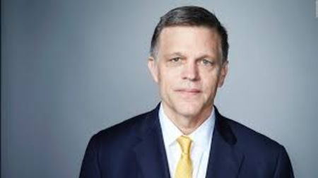 Douglas Brinkley in a black suit poses for a picture.